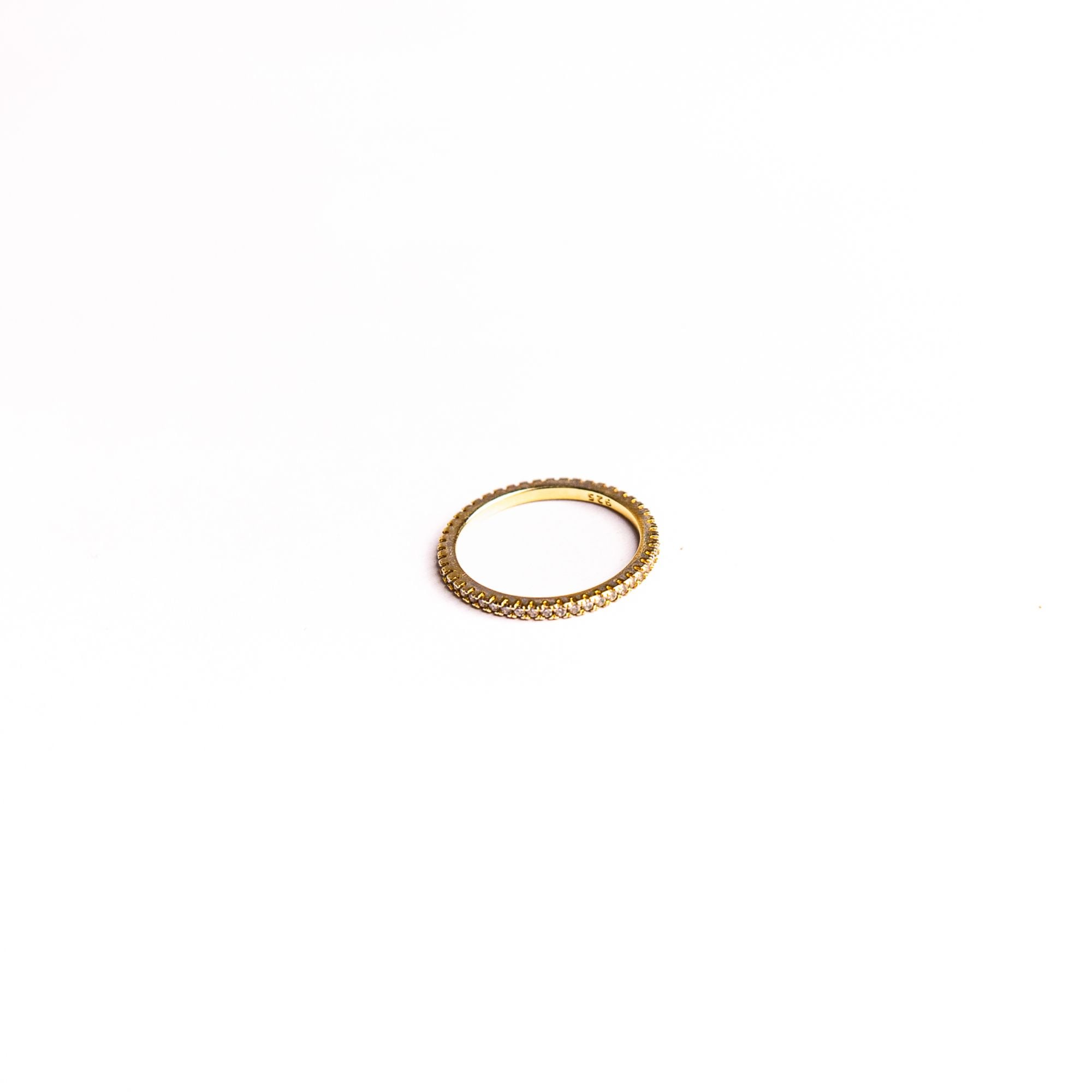 Amara ring on a white background: a thin band set with clear stones all the way around.