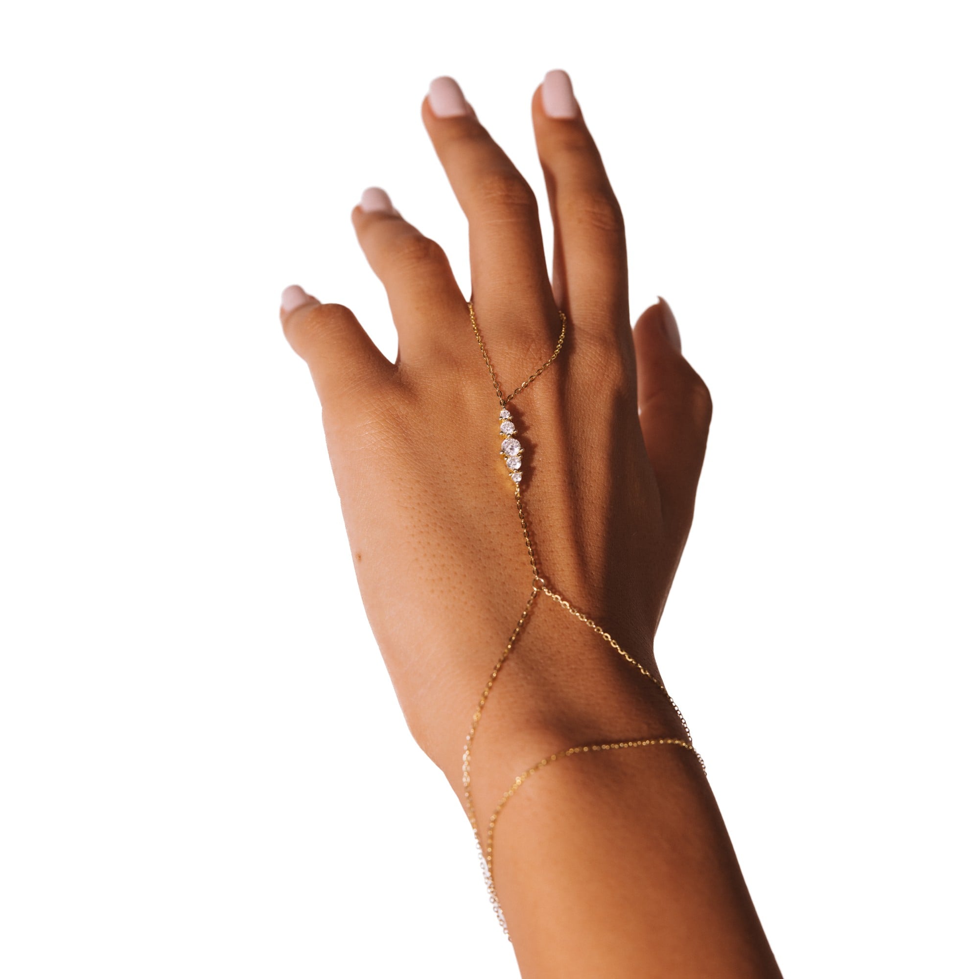 Amira hand chain on a raised hand against a white background, a line of stones across the back of the hand.