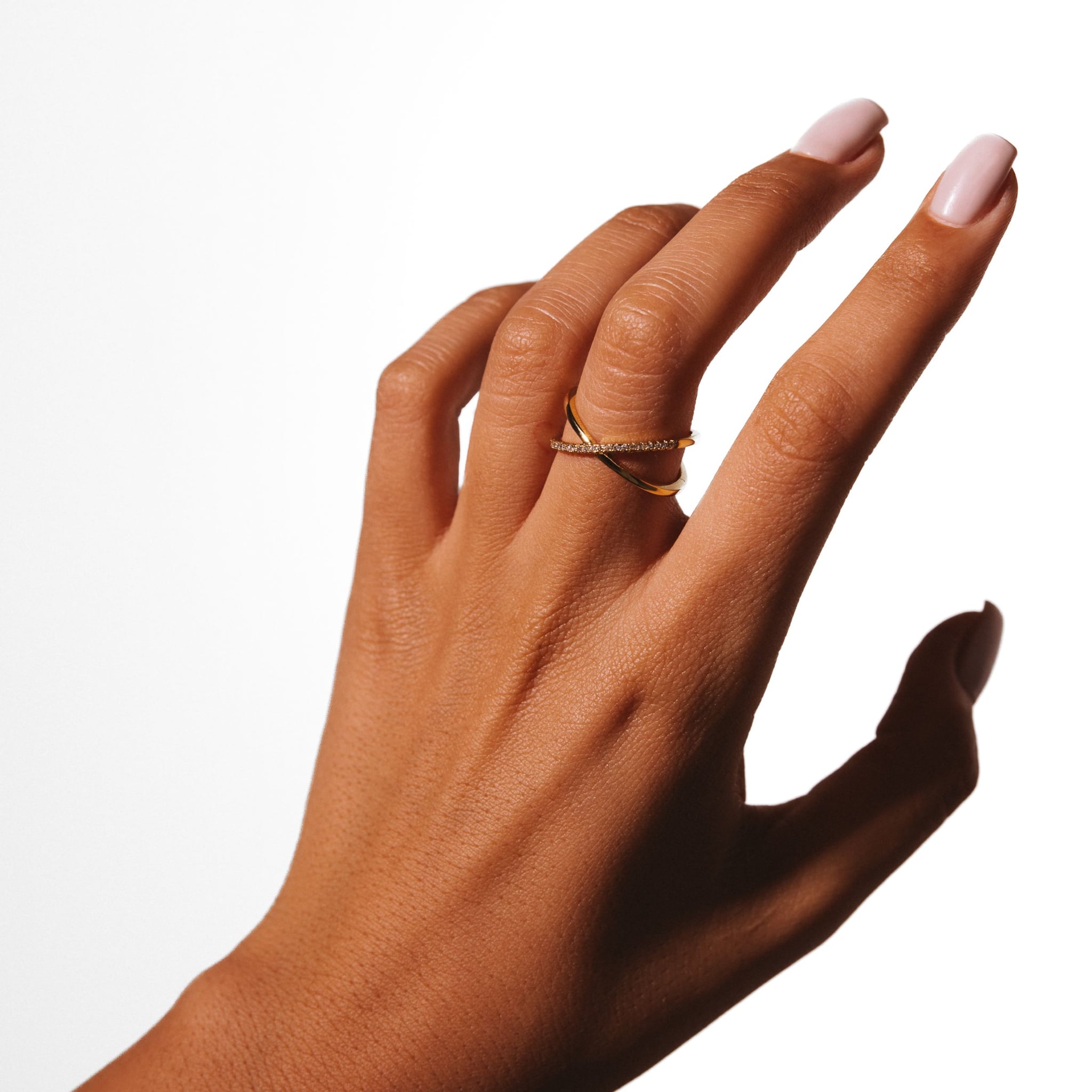 Azalea ring worn on a raised hand against a white background.