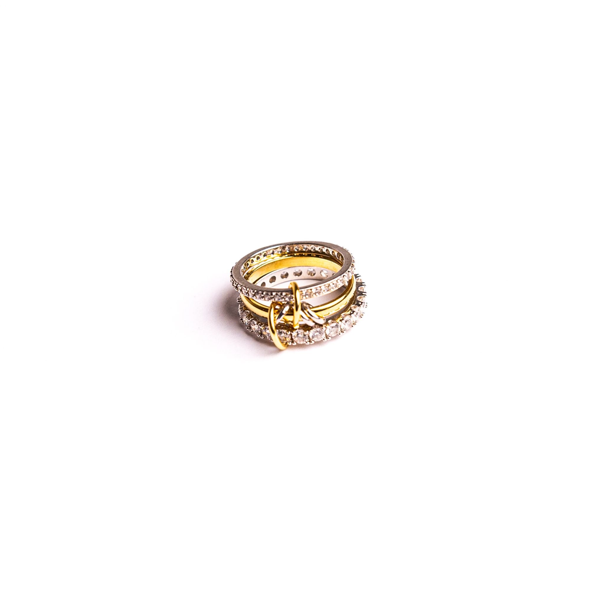 Chamilla ring on a white background: several bands of different widths joined in one piece.