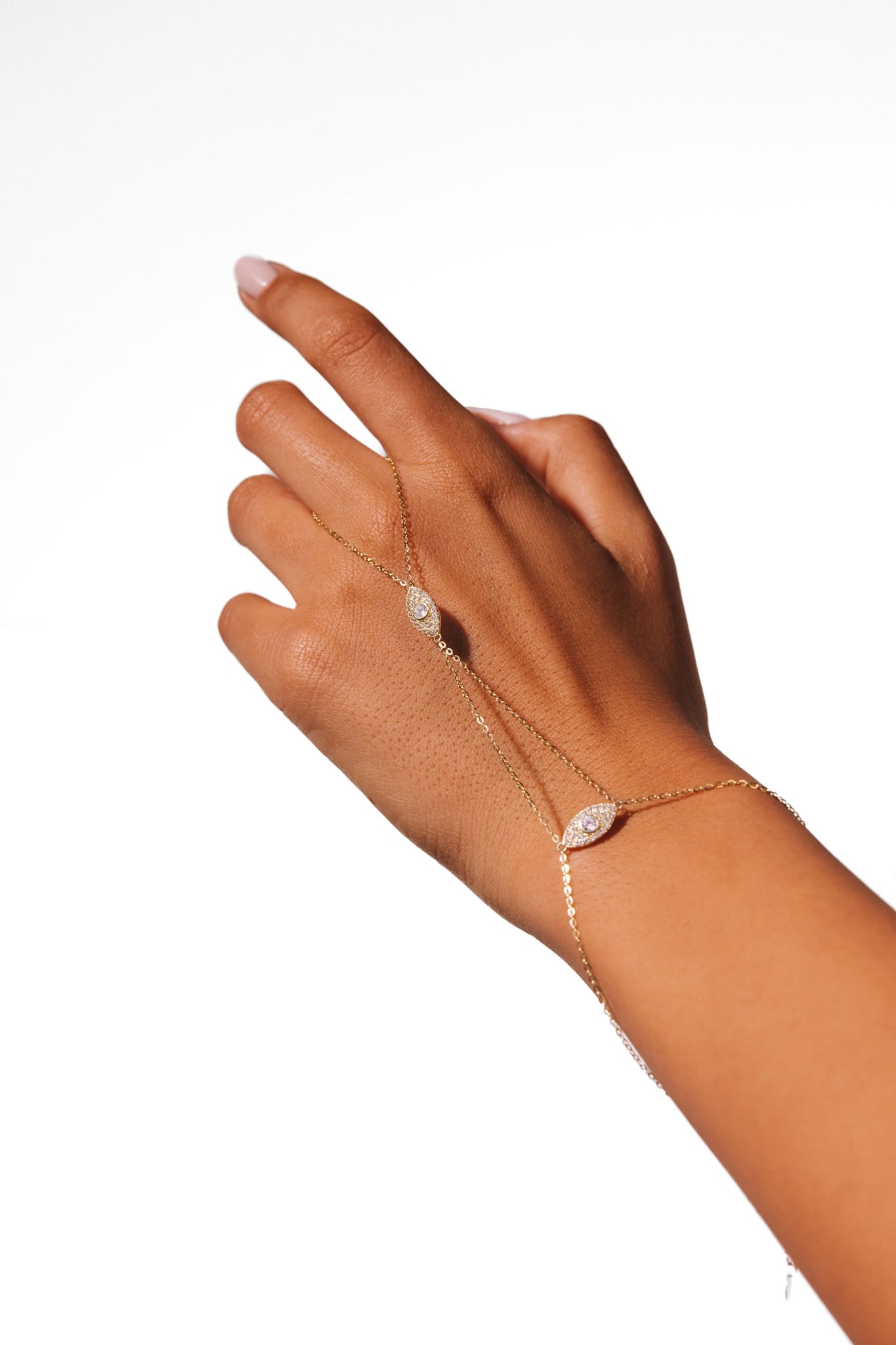 Dahlia hand chain worn on a hand against a white background, with two mirrored marquise details.