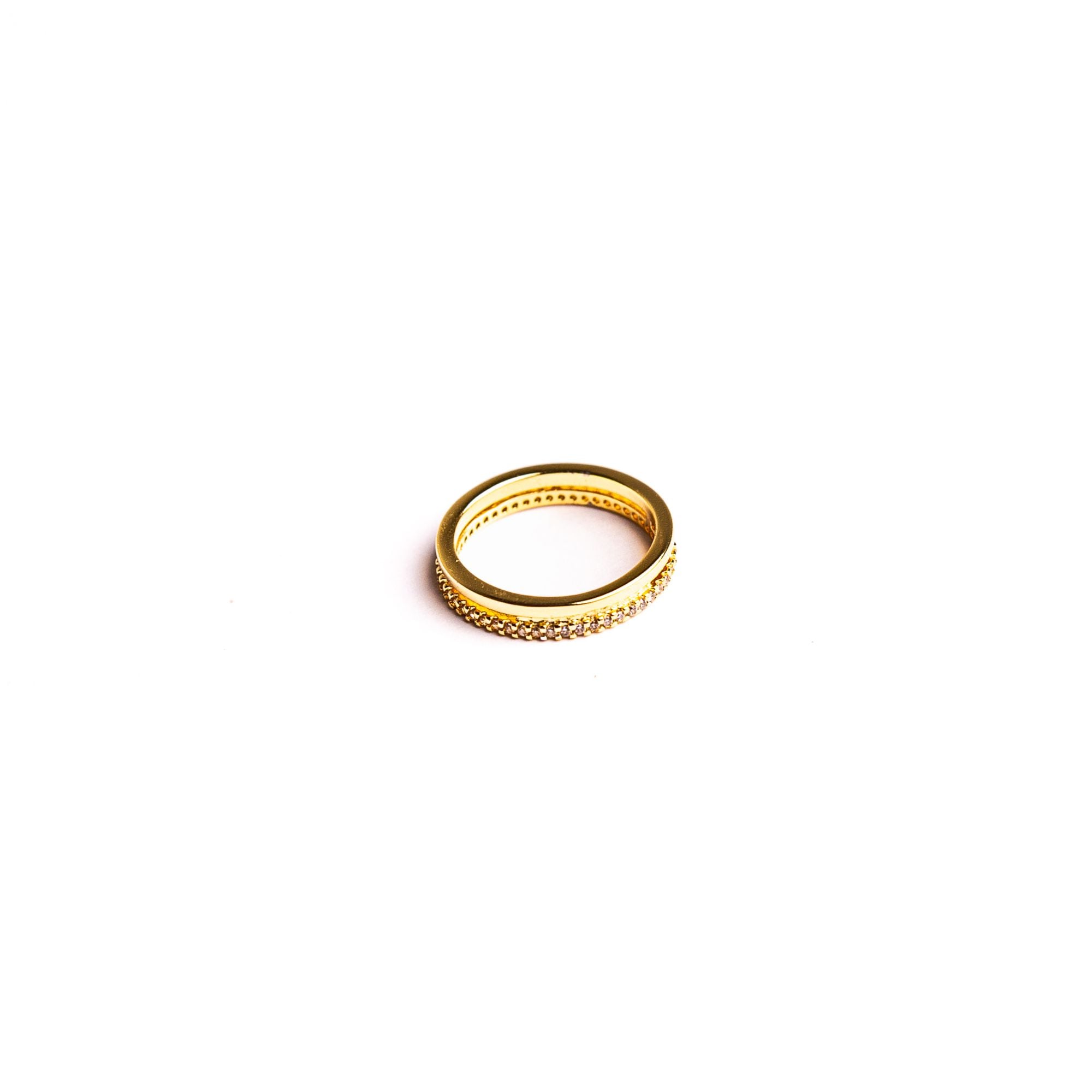 Inara ring on a white background: two bands, one smooth and one traced with small stones.