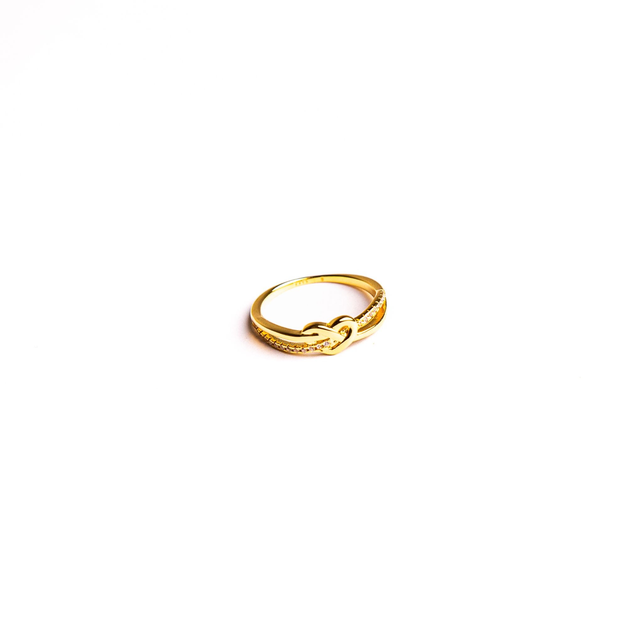 Iris ring on a white background: two slender bands tied in a heart-shaped knot.