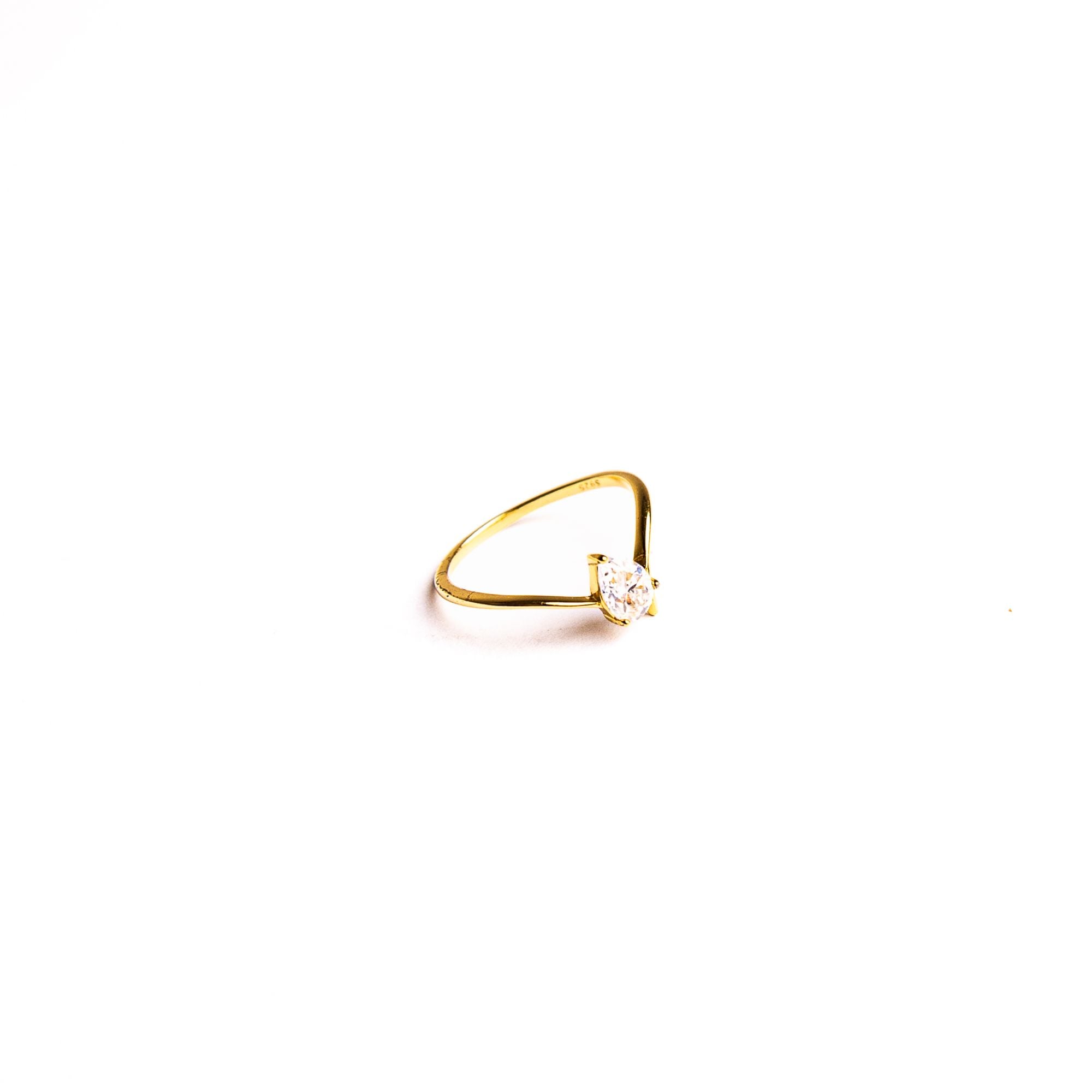Jade ring on a white background: a slim band lit by a single clear stone.