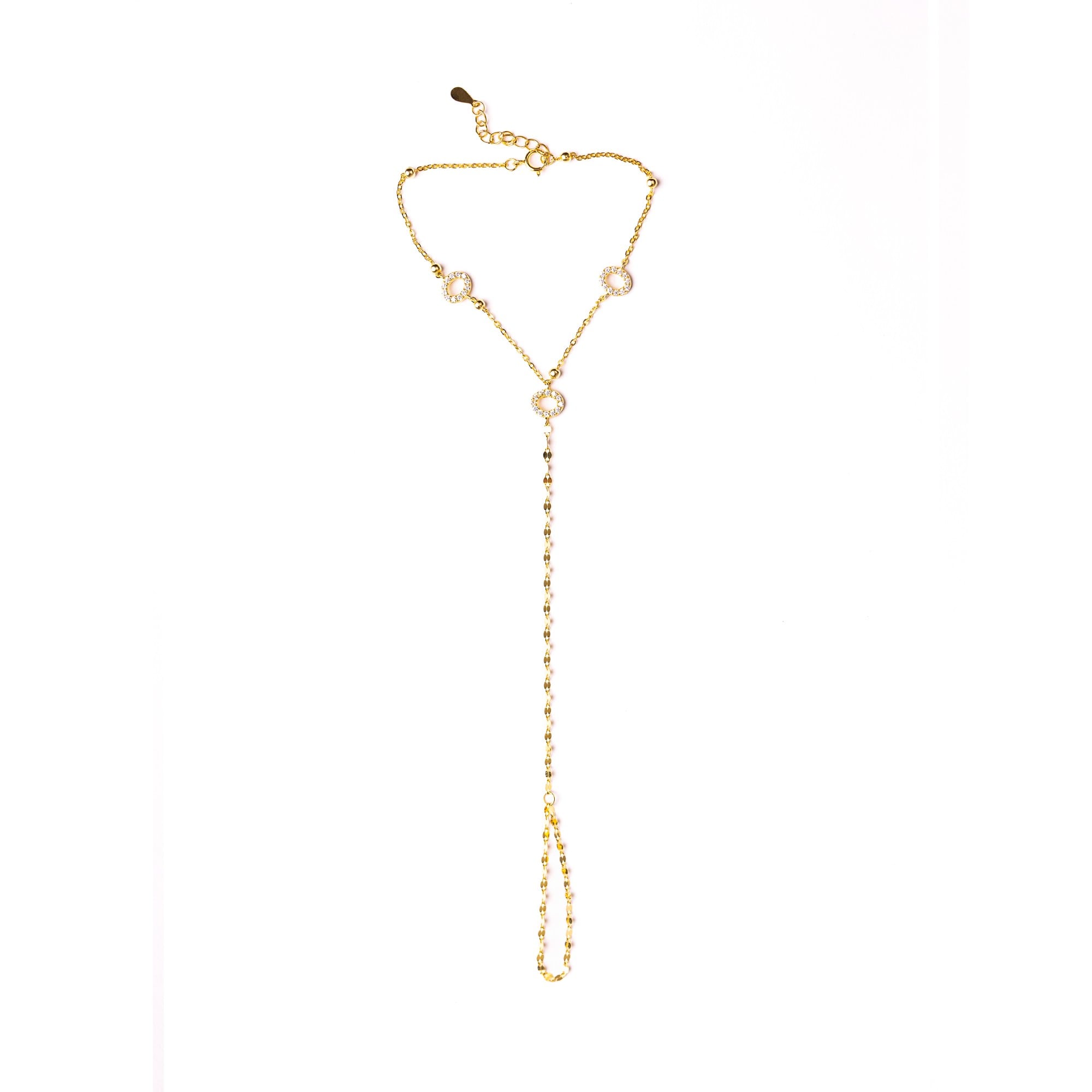 Jasmin hand chain laid flat on a white background, with small clear stones along the chain.