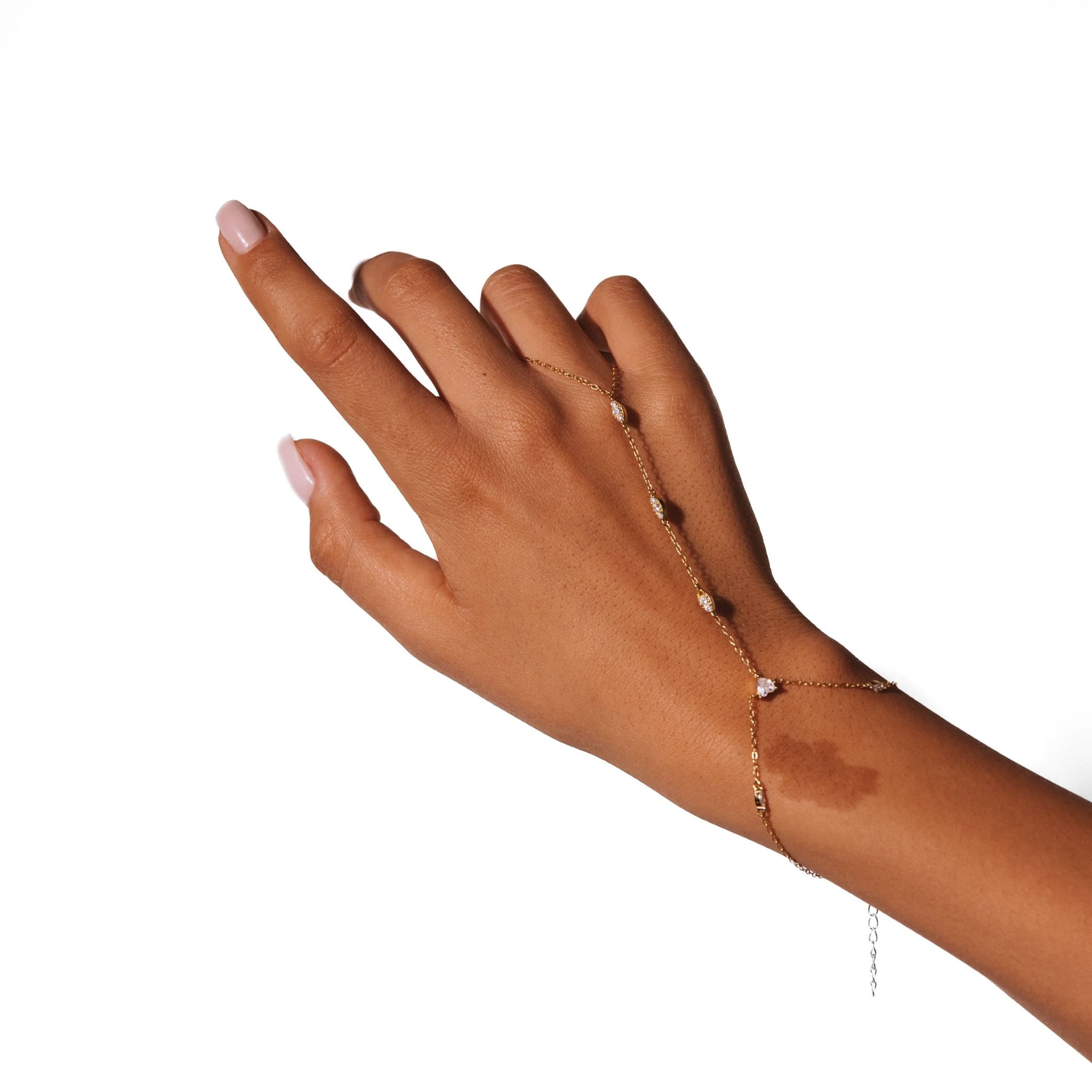 Loulya hand chain worn across the back of the hand, against a white background.