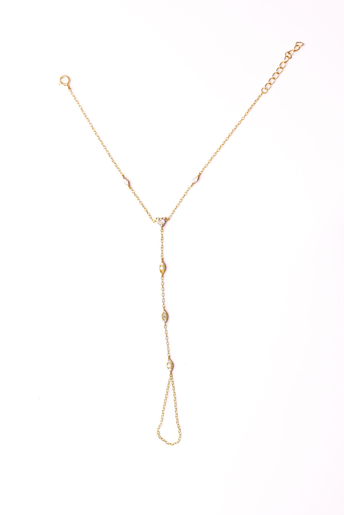 Loulya hand chain laid flat on a white background: a fine chain with clear stones.