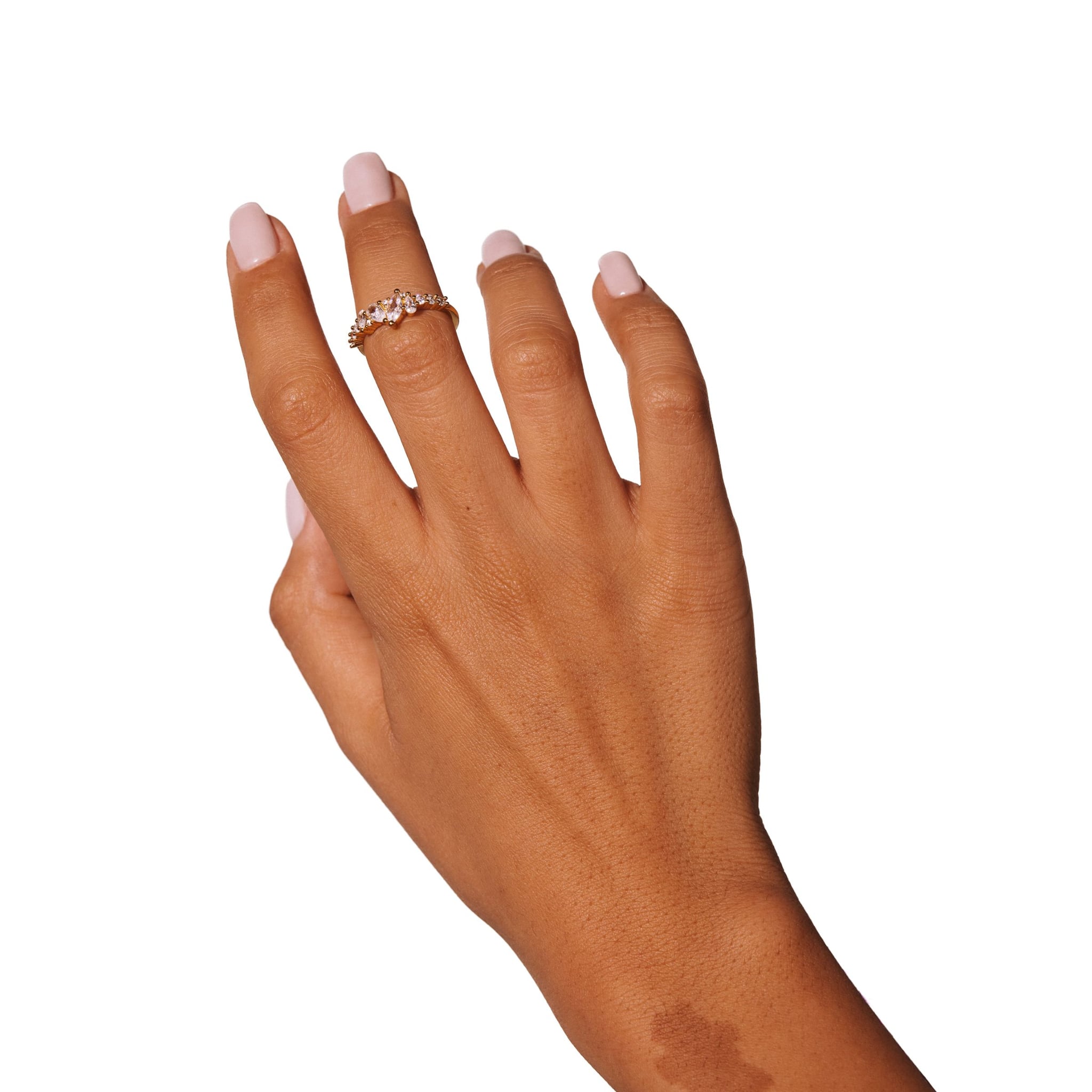 Mimosa ring worn on a raised hand against a white background.