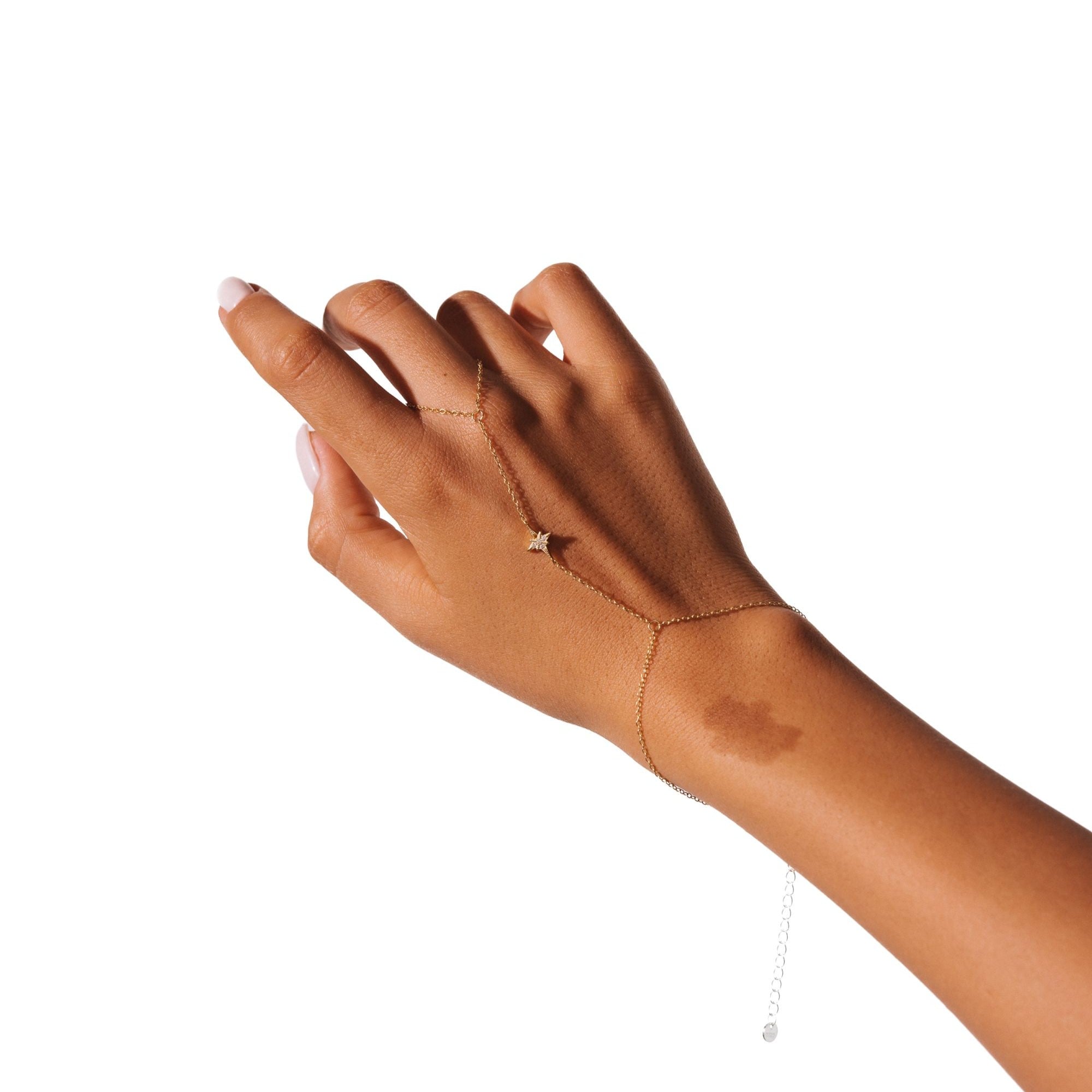Nour hand chain on a white background, a small star resting at the centre of the hand.