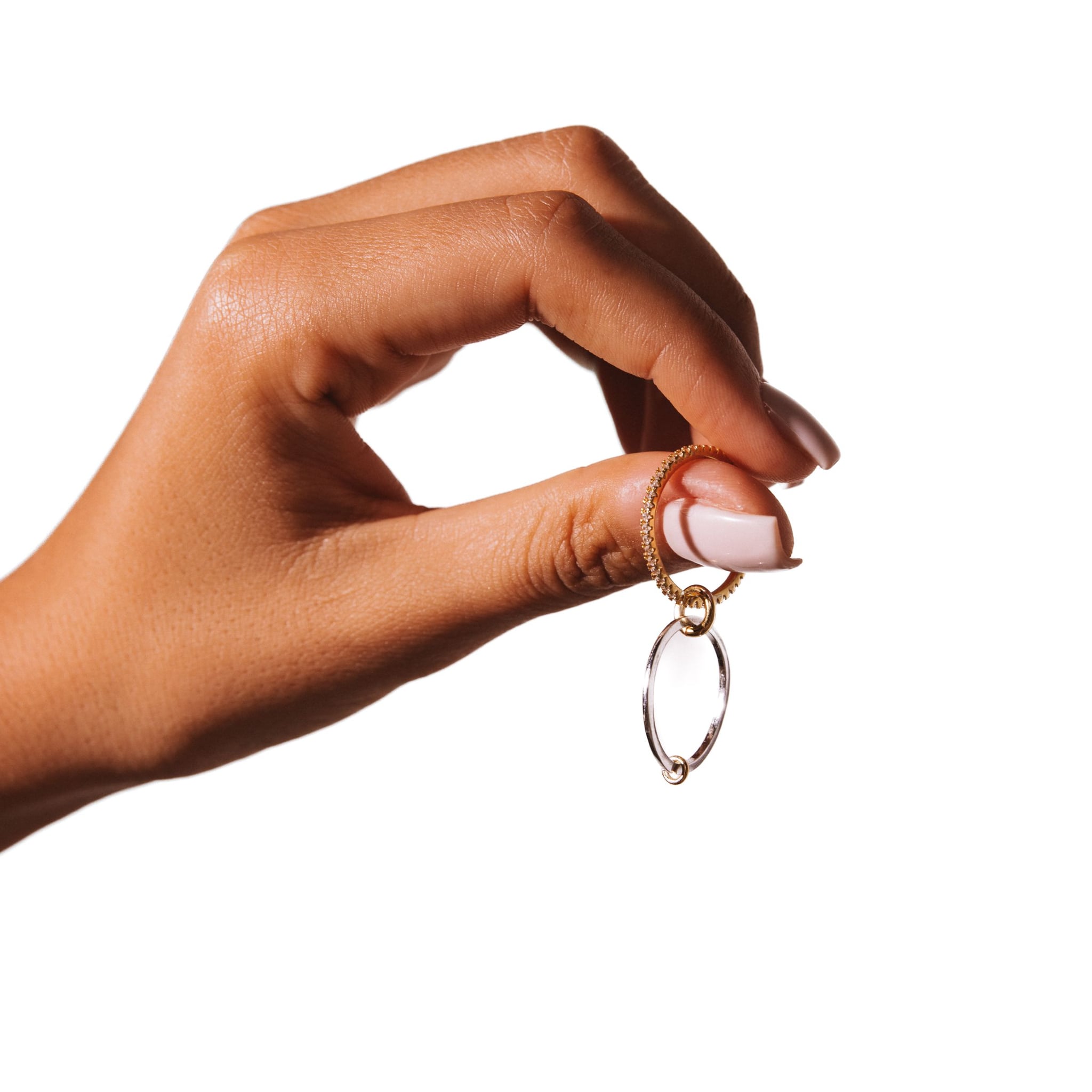 Yellow Lady ring held open between the fingers against a white background.